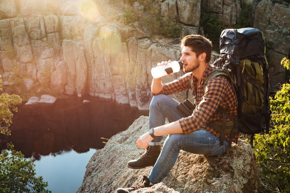 A man drinking water from a water bottle