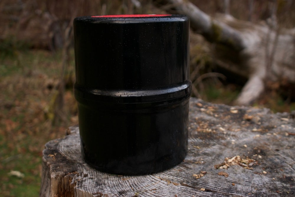 Black bear canister on a tree stump