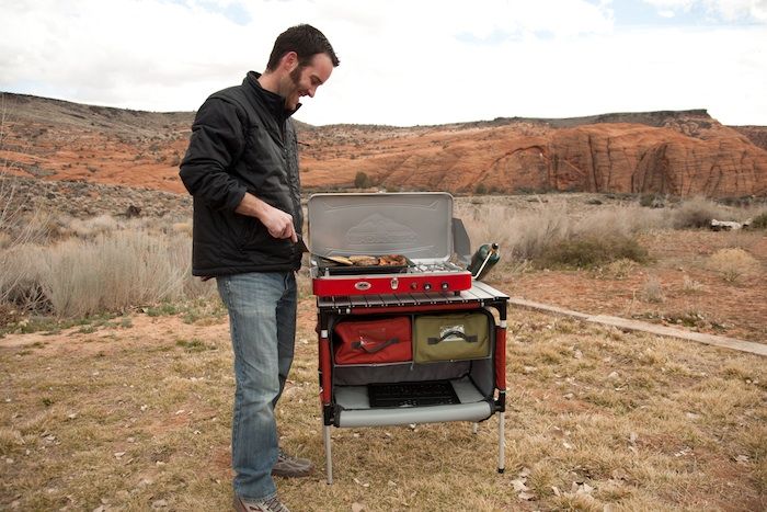 A man cooking using a camp table