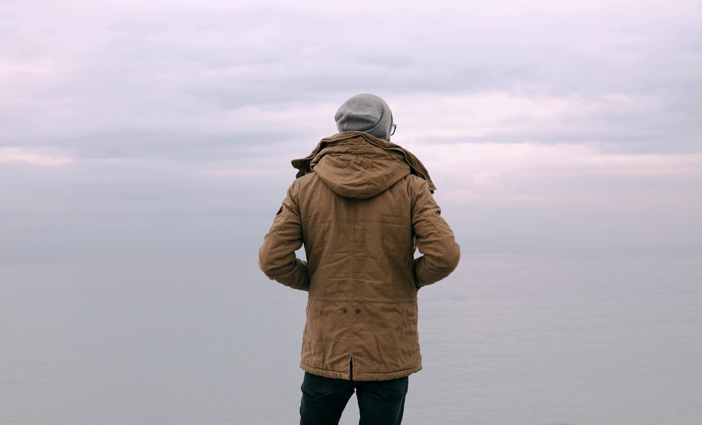 Guy in parka coat looking at horizon