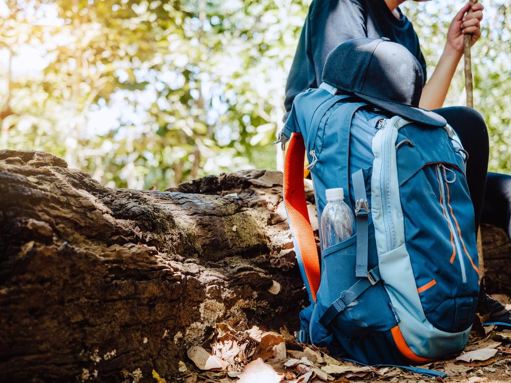 Hiker during rest with her bag in the ground