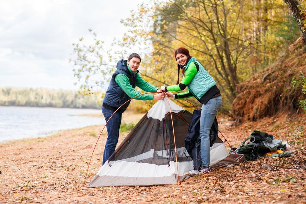 Couple setting up a tent