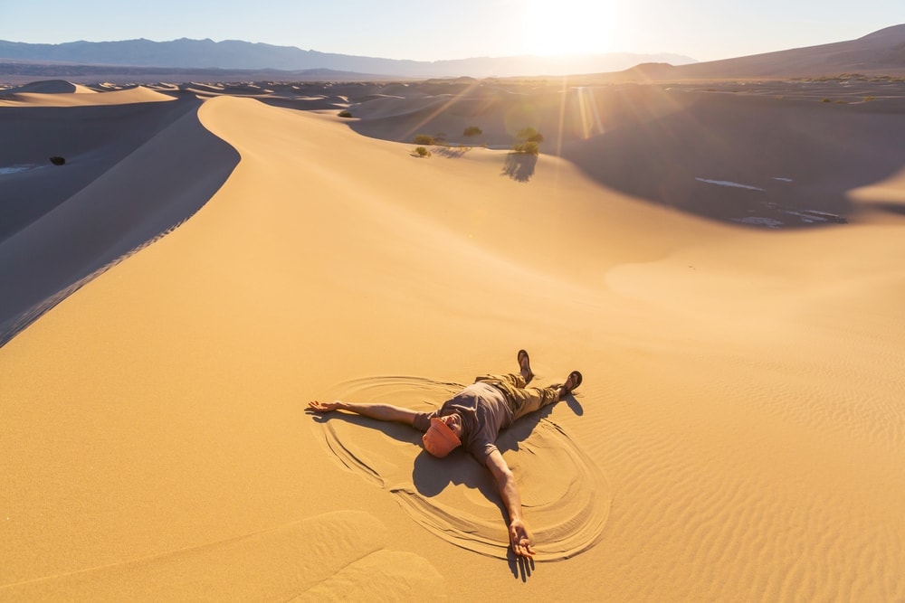 Man lying in desert sand