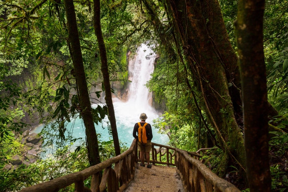 Man going down to a waterfall