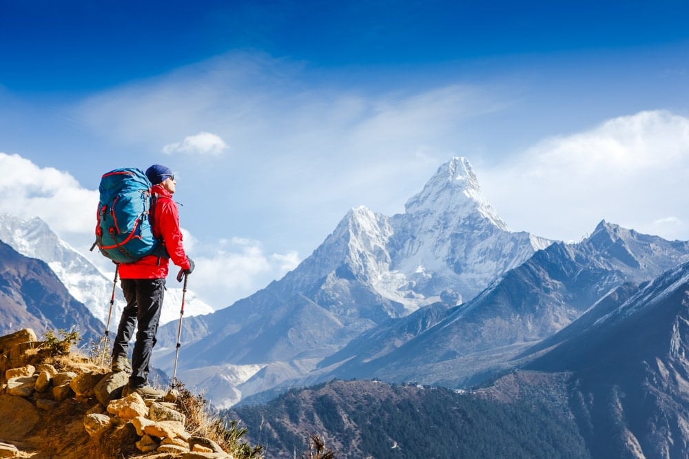 A hiker standing on top of the mountain