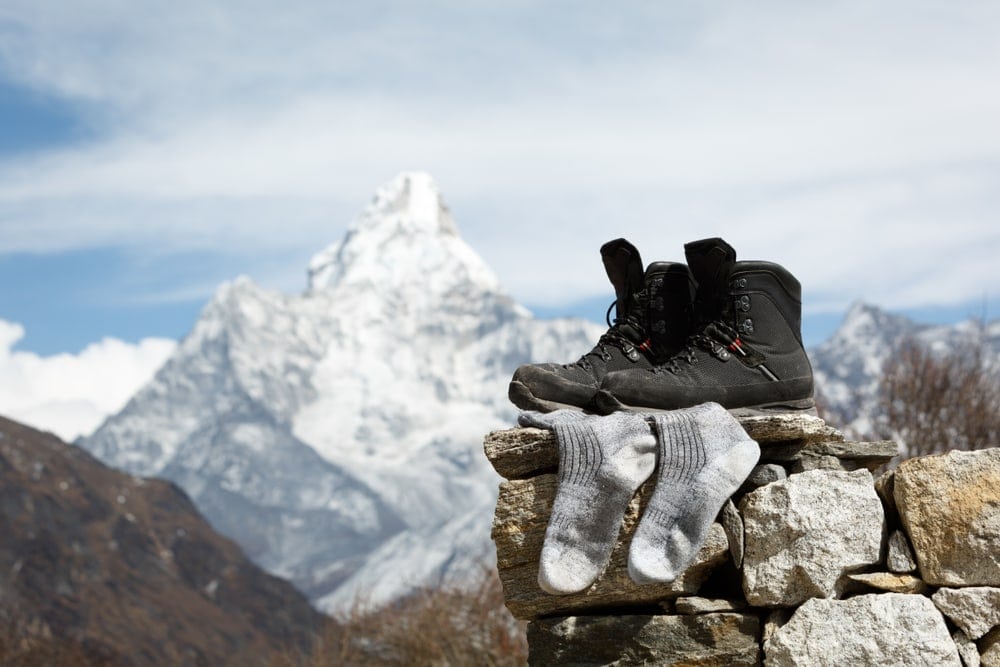 Camping boots and socks on a pile of rocks