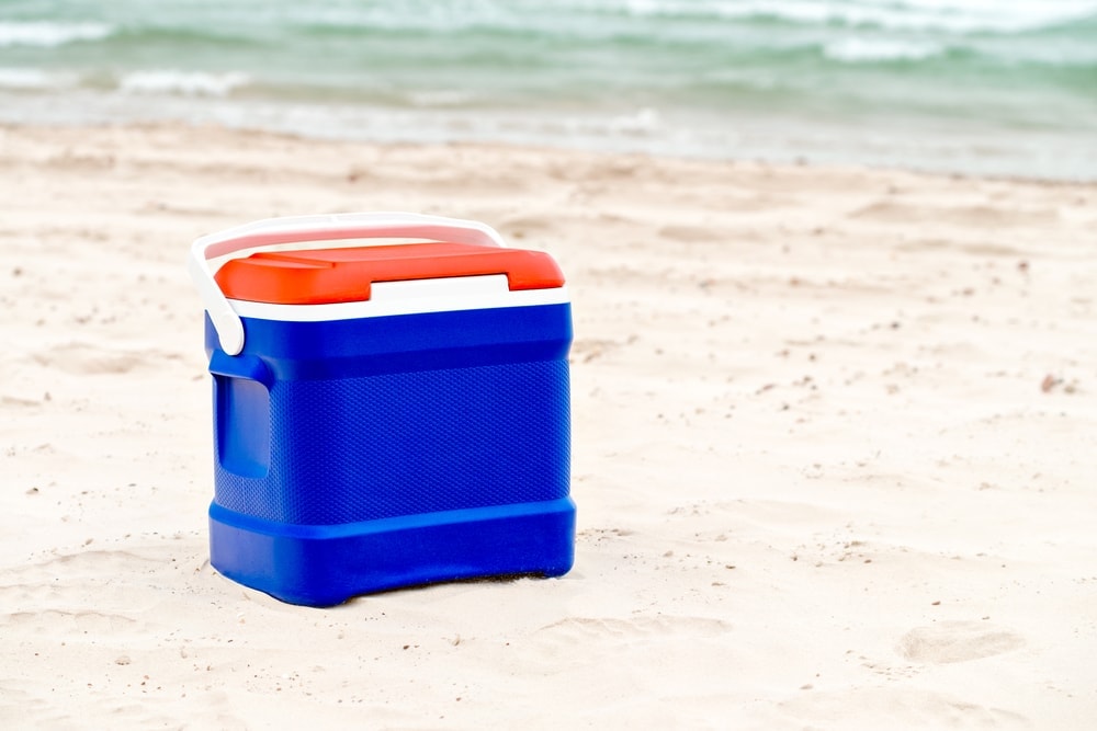 Cooler on the beach sand during beach camping