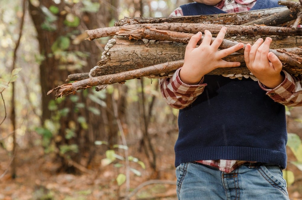 Child carrying firewood for camping