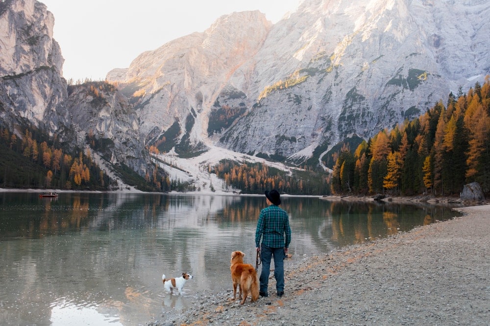 Man holding his dog while camping