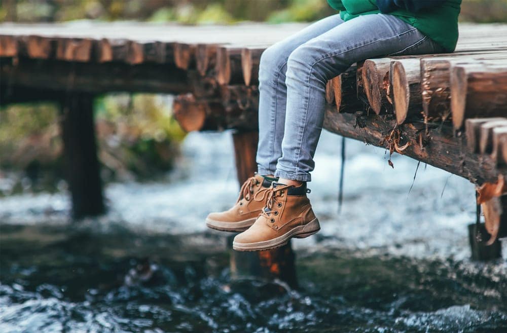 Person sitting on a bridge