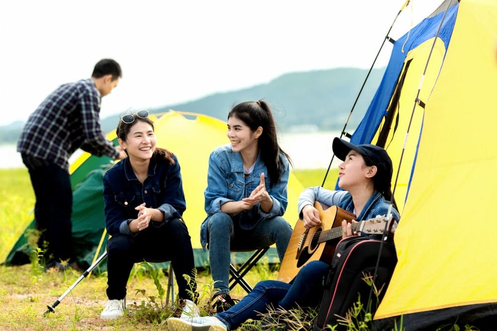 Group of friends hanging out and playing camping games
