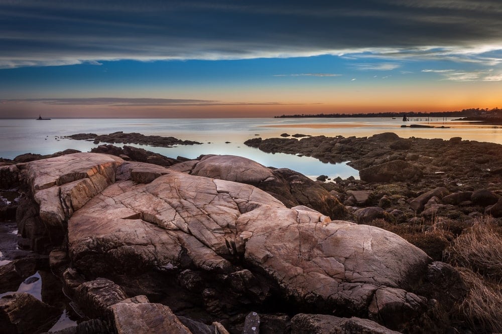Boulders on the shore during sunset