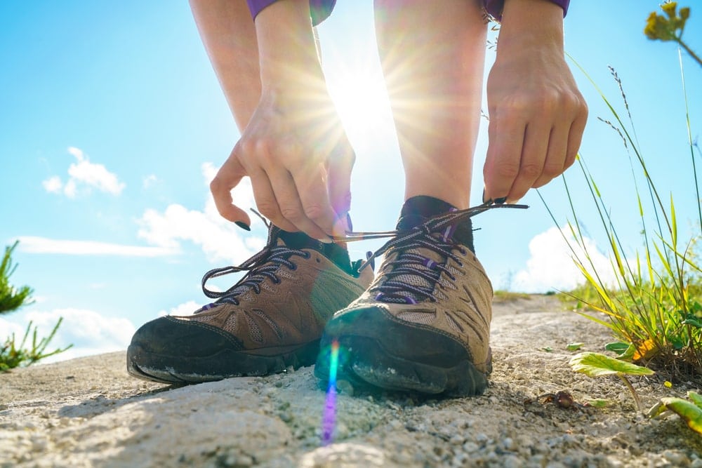 Hiker tying her hiking shoelaces