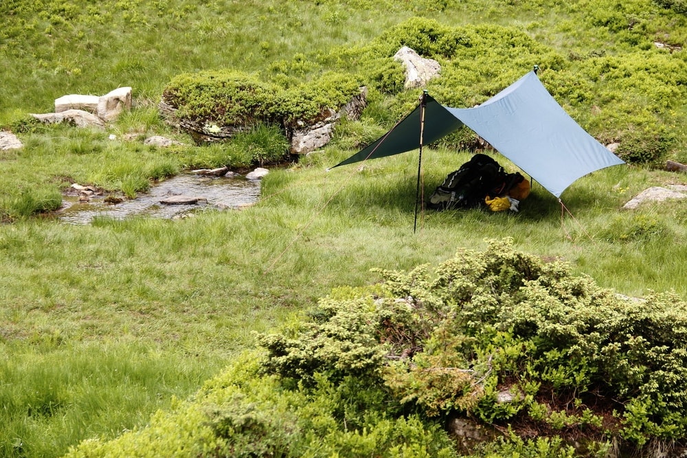 Tarp shelter near a stream