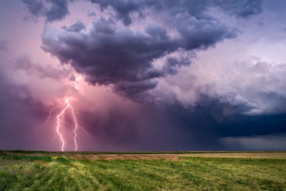 Thunderstorm and lightning on a wide field