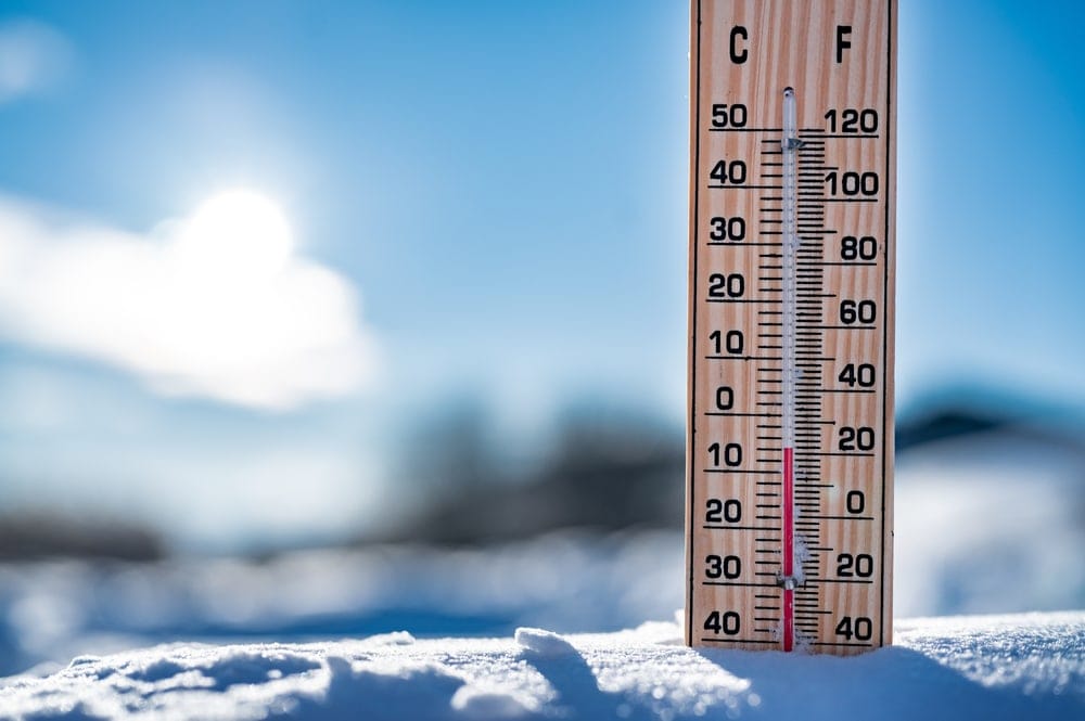 Thermometer on snow shows dropped temperature resulting to cold wave, a type of natural disaster