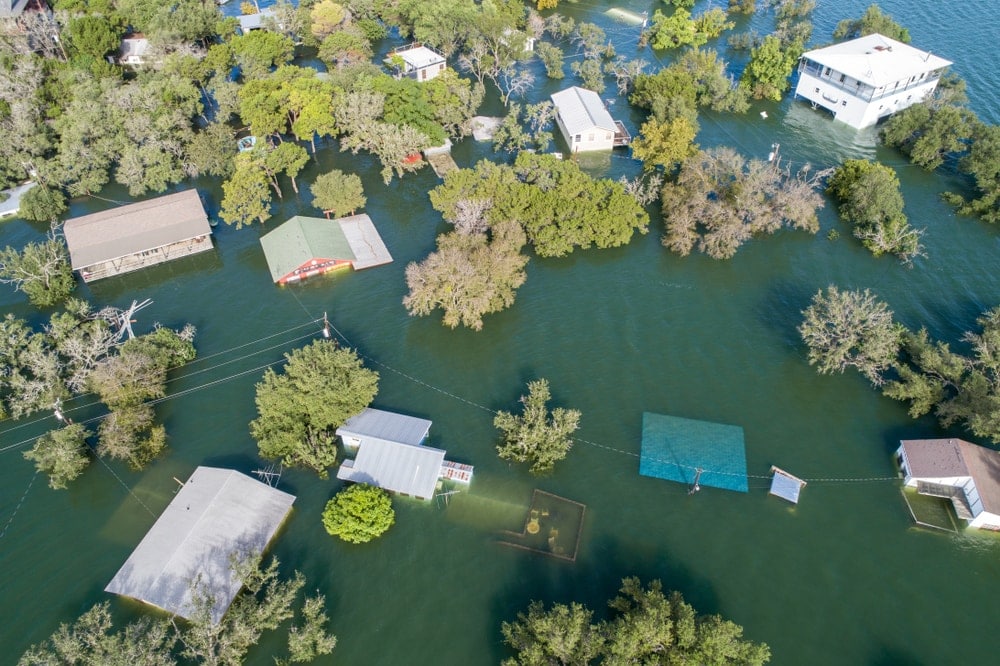 Homes being destroyed and submerged under water caused by a flood