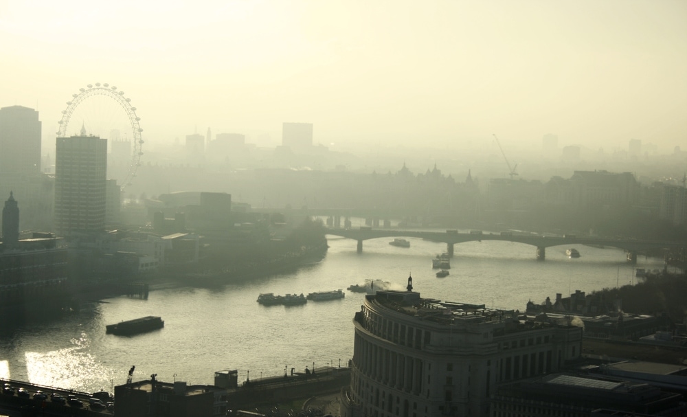 Urban city covered by pea soup fog