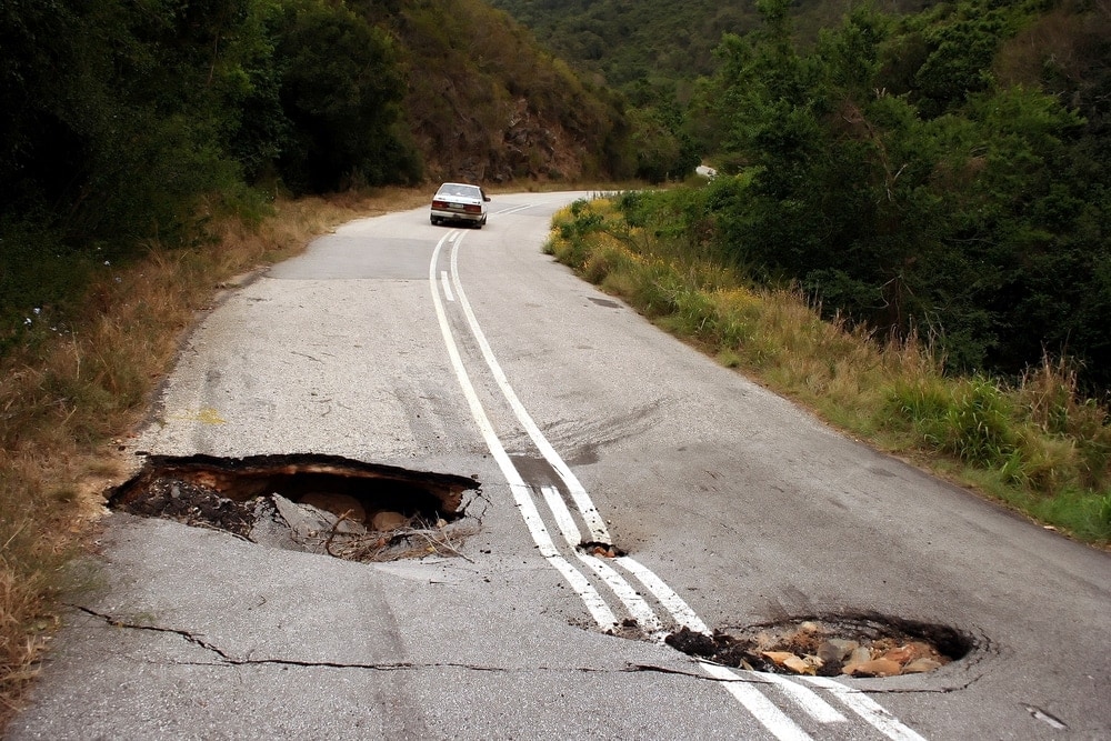 Damaged road with sink holes