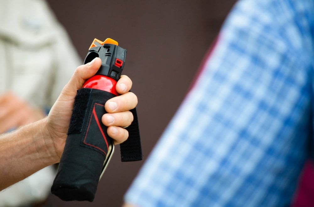 Man holding a bear spray for bear attack