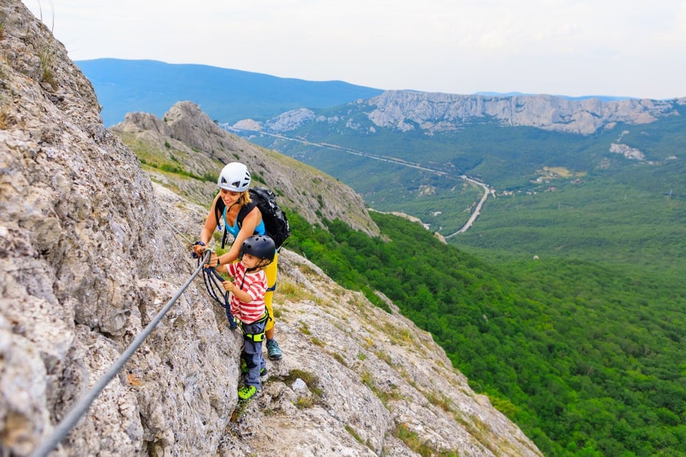 Mother and son climbing together