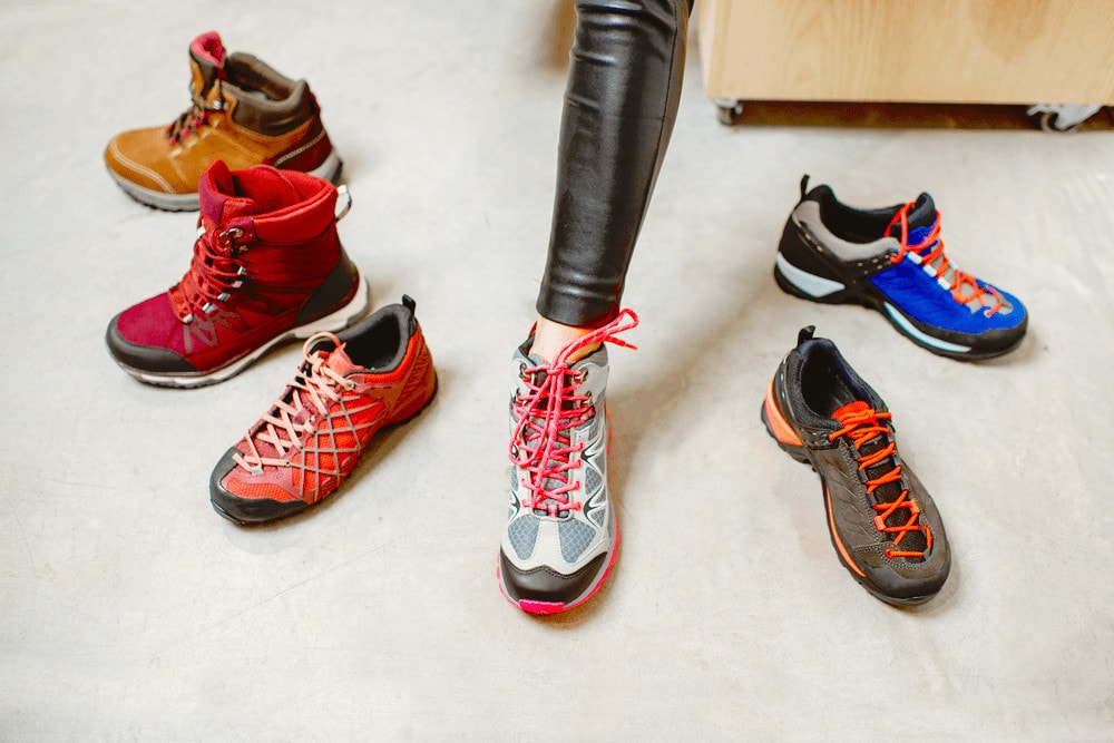 Woman fitting different hiking shoes