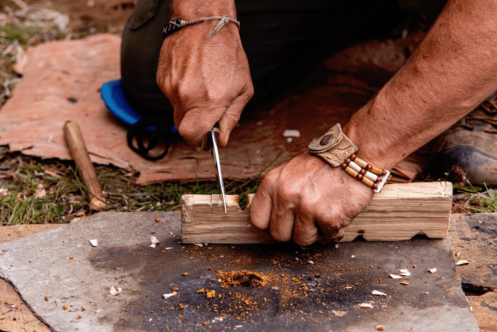 Man preparing a fireboard for fire