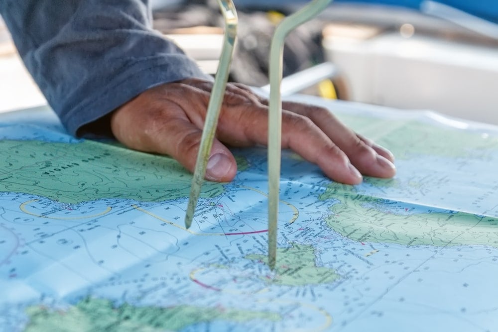 Ship captain using navigational map