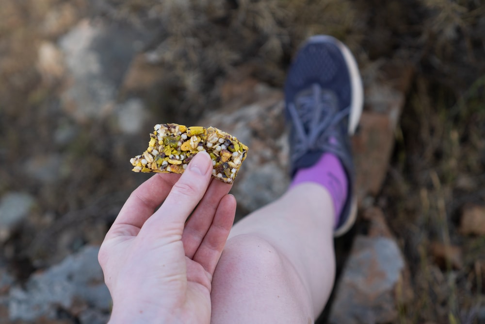 Hiker holding a granola bar