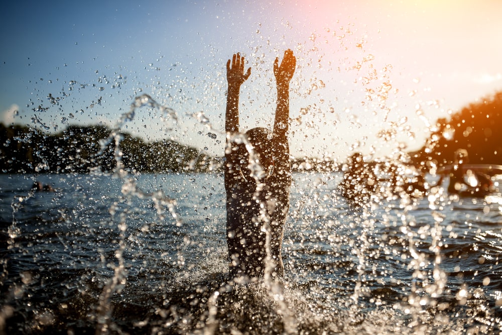 Kid splashing waters from lake