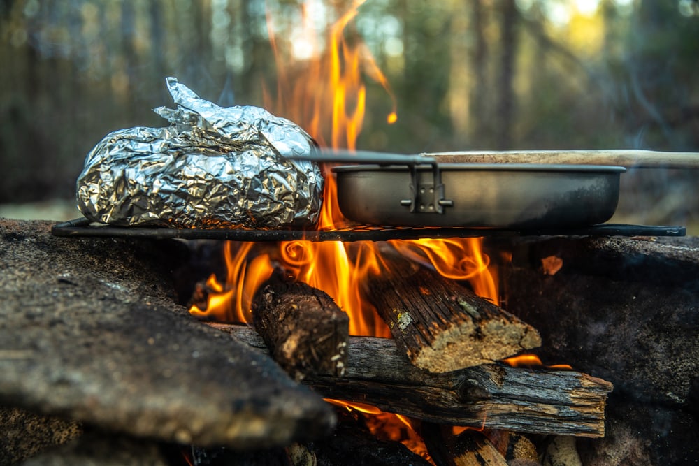 Campfire cooking over the coals in the wilderness