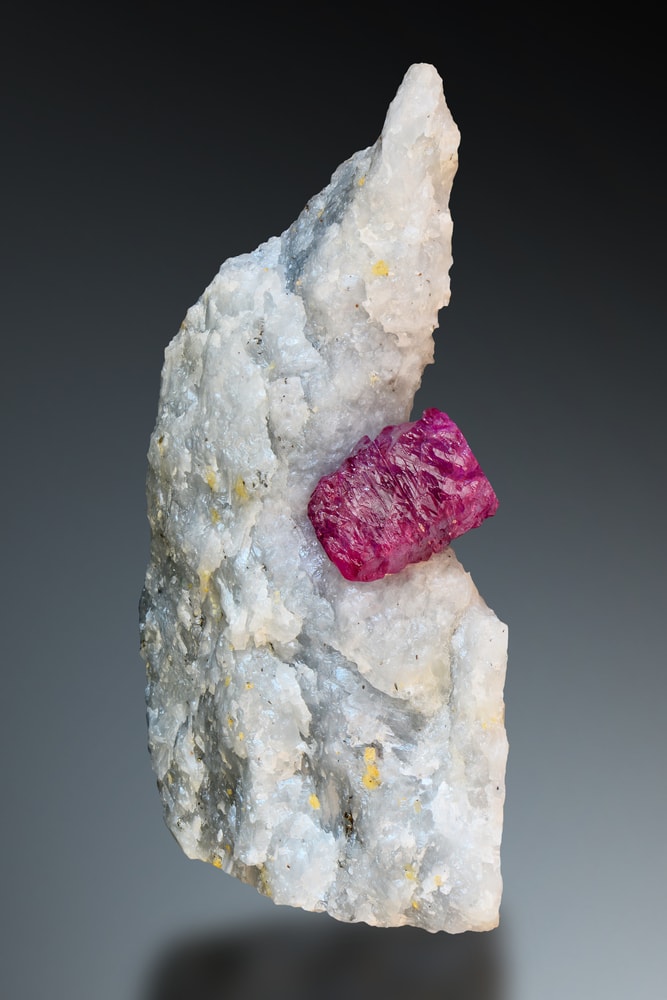 a Burma ruby on a marble from Mogok, Burma.