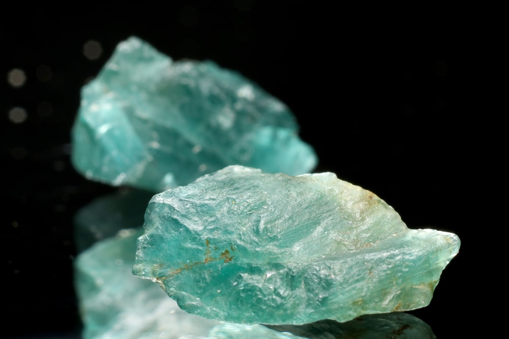 on of the rarest type of gems on Earth, the Grandidierite from Napuana Quarry, Madagascar on a black background 