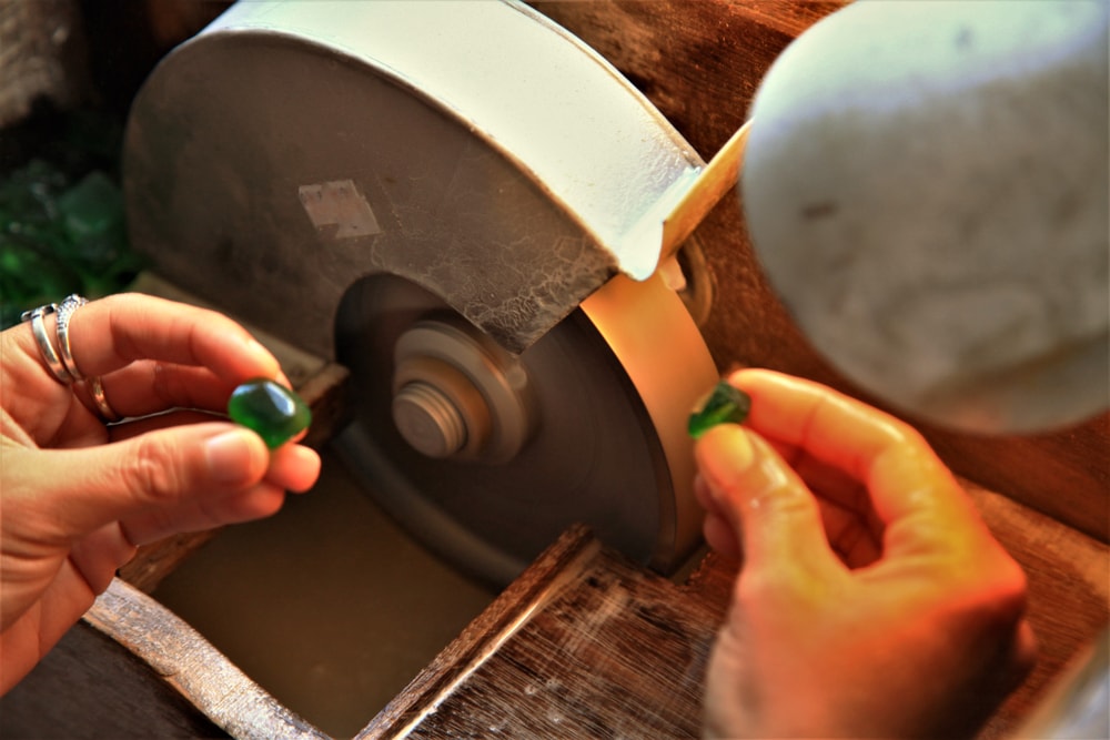 A lapidarist in the process of cutting and polishing gems.
