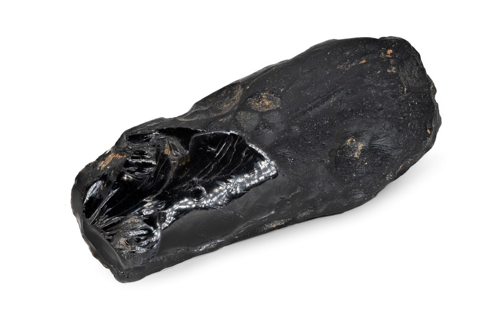 one of the types of gems from outer space - close up of a tektite stone isolated on a white background
