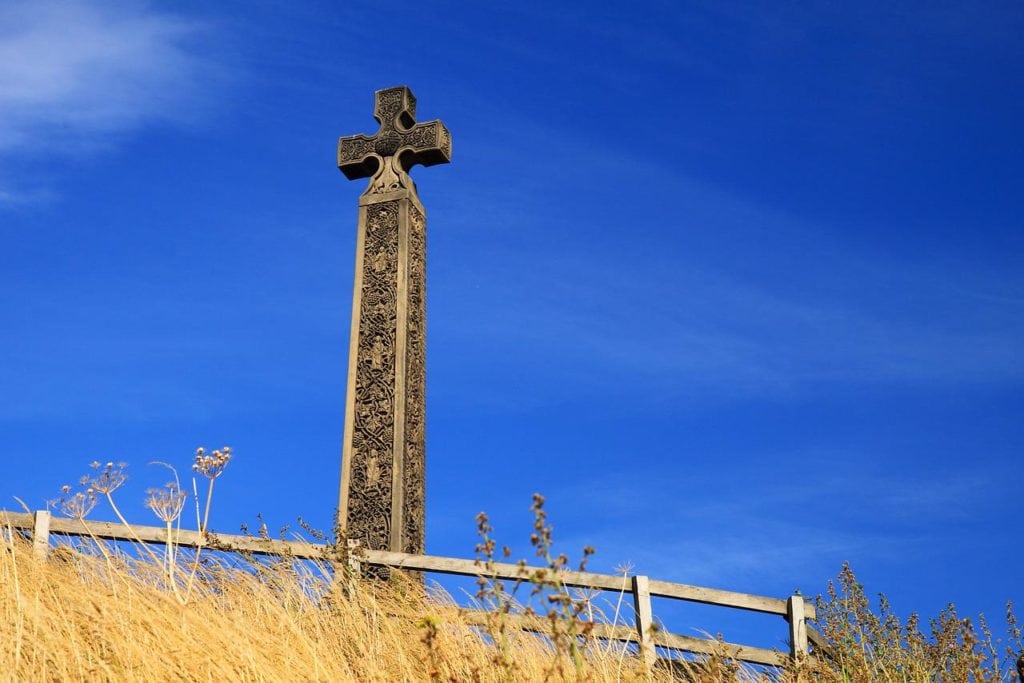 an ancient cross on a cemetery representing Celtic culture