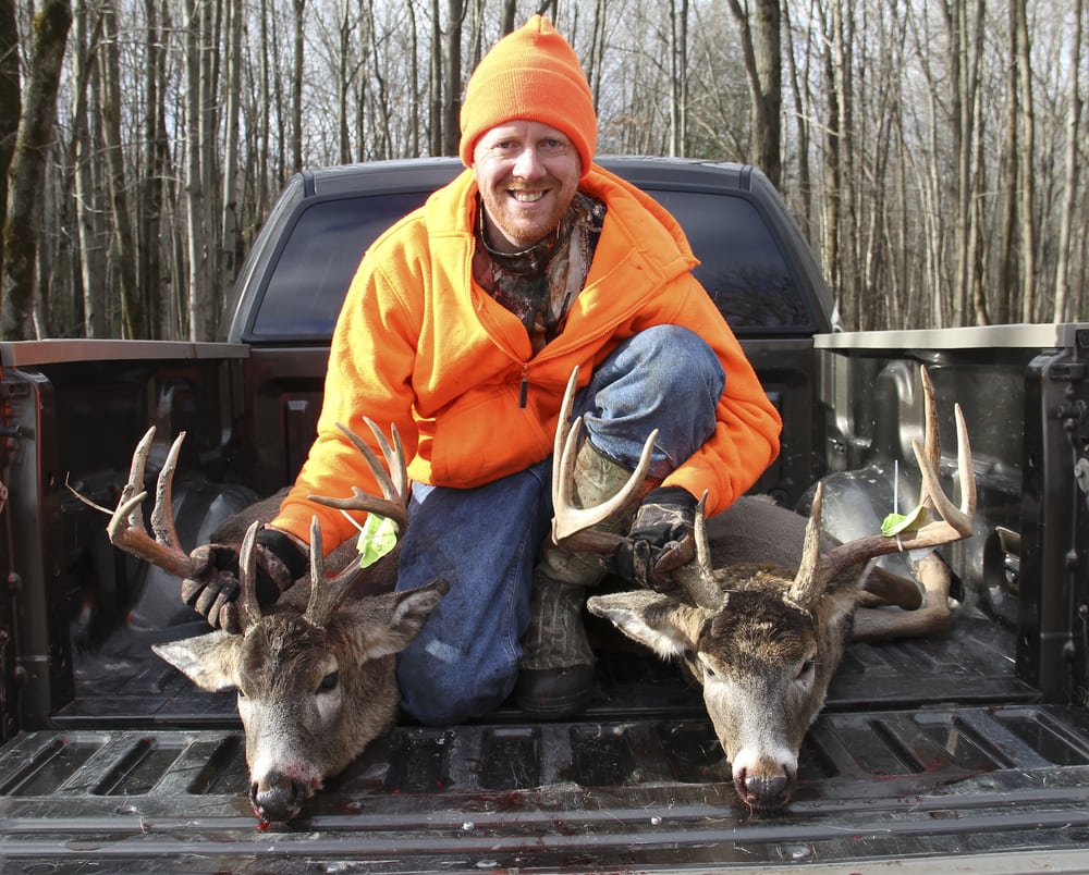 Hunter holding on deer's horns