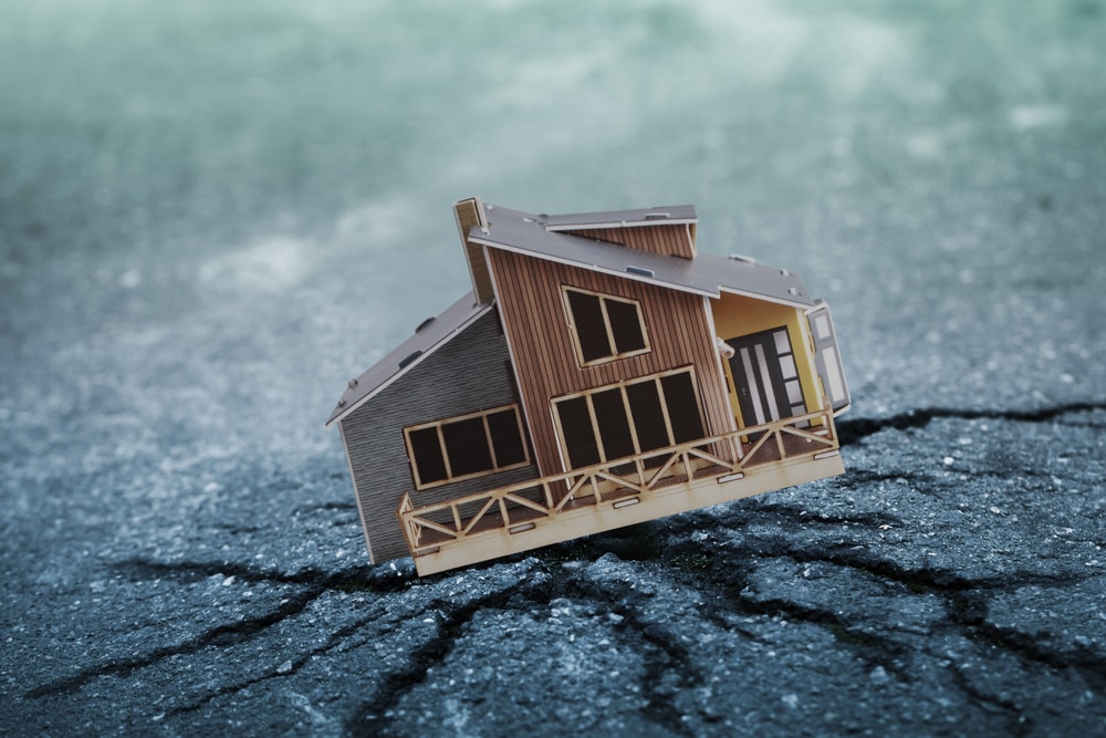 a house falling on road crack due to earthquake illustration
