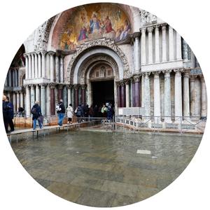people walking on scaffolding due to flood in Venice
