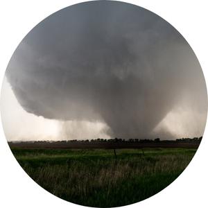 a wedge tornado forming on a grassfield