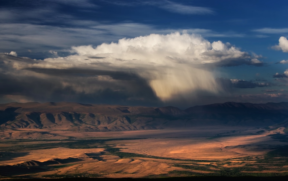 Virga clouds landing off a mountain