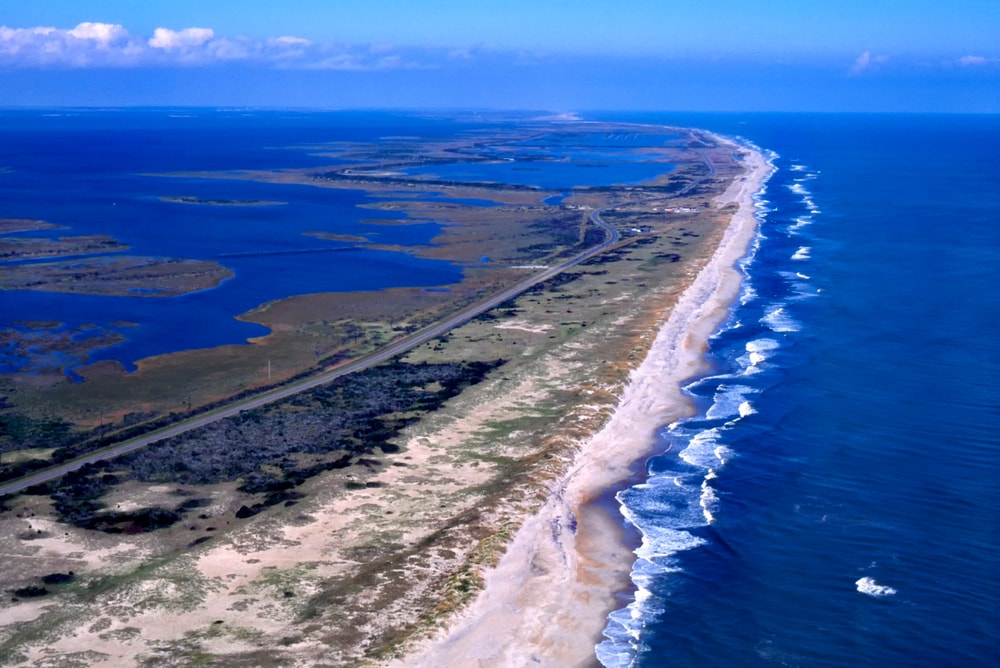 Aerial view of an estuary and the blue ocean