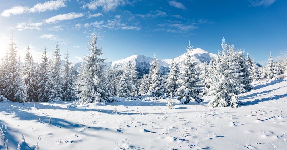 Cirrocumulus Clouds on top of a snowy mountain