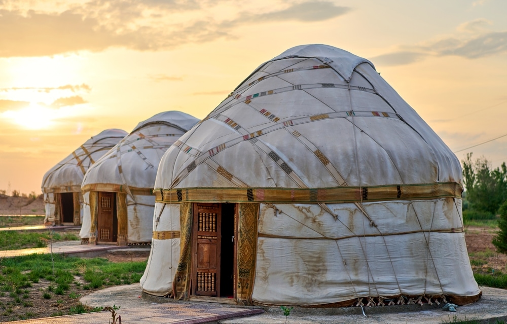Three yurts in the middle of sunset