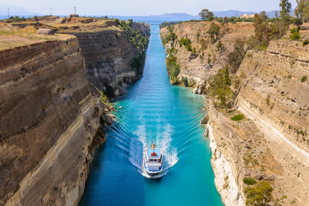 Boat going through canals in the middle of mountains