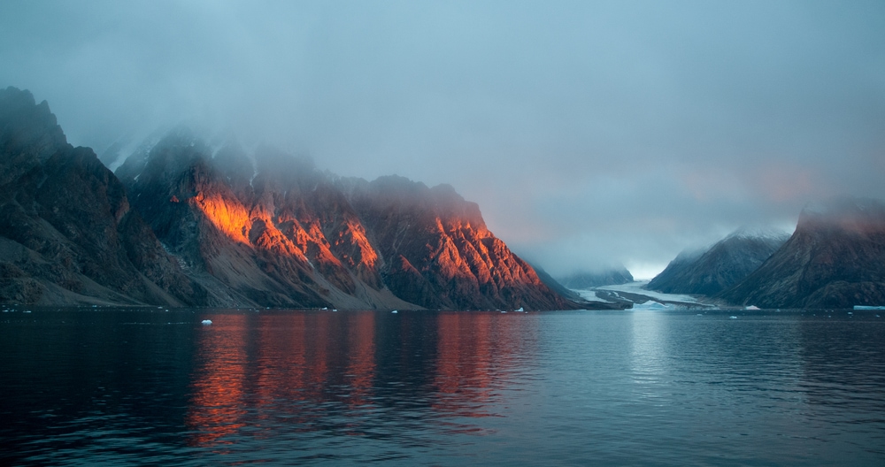 Fjord with a lot of fogs above the mountains