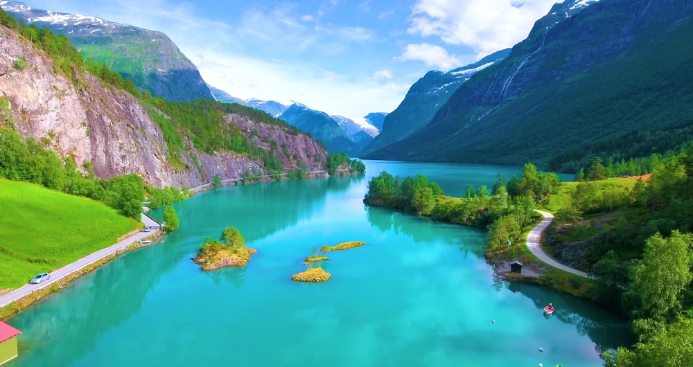 Blue waters on fjord with road on a side