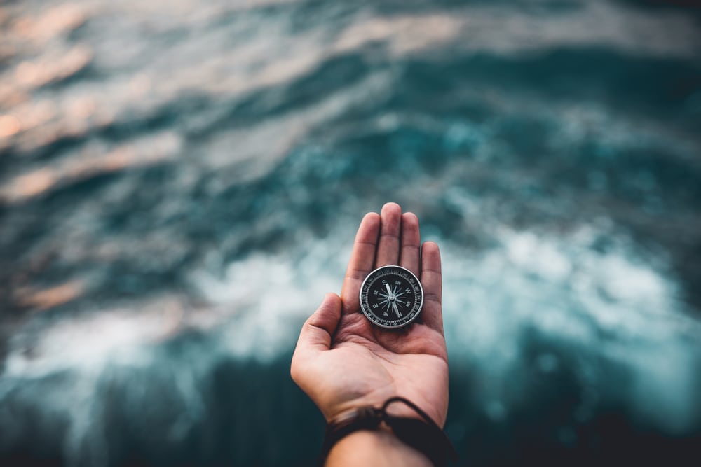 man holding a compass