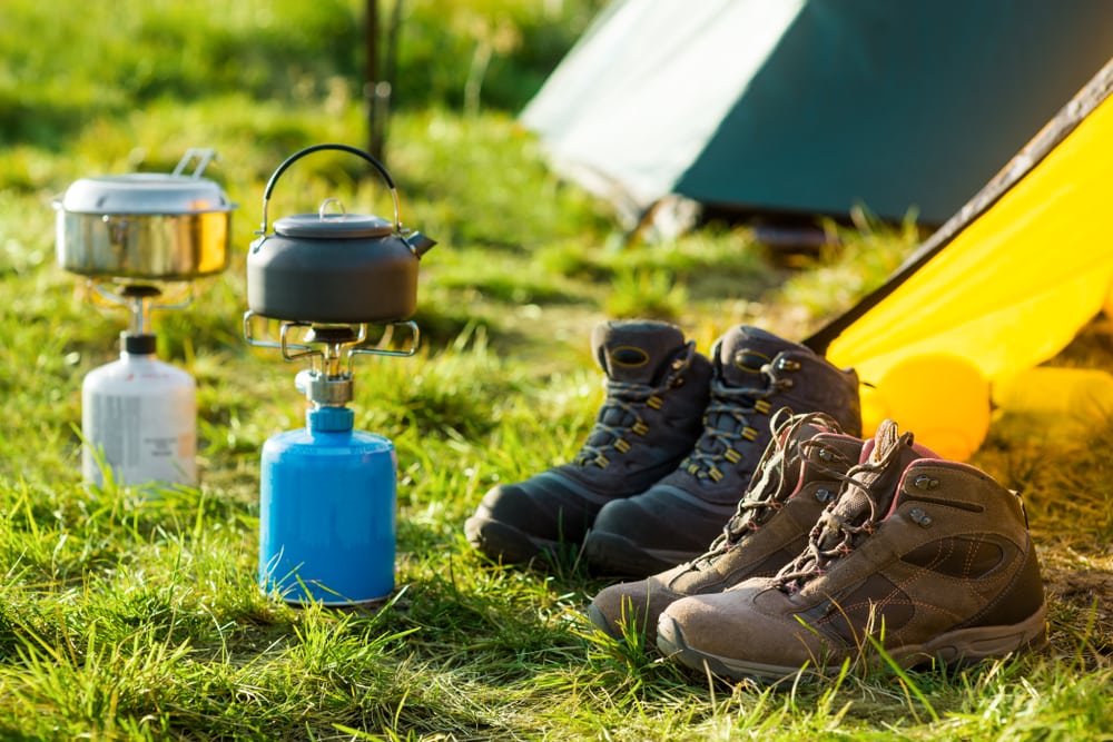 hiking boots beside a propane tank