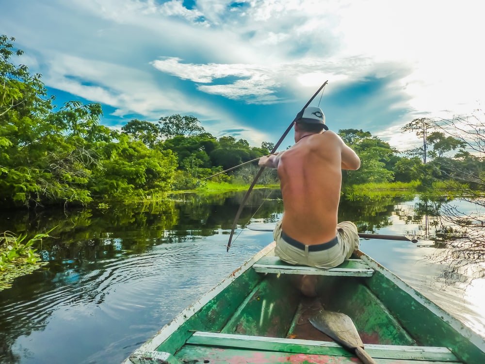 Man bow fishing on a lake